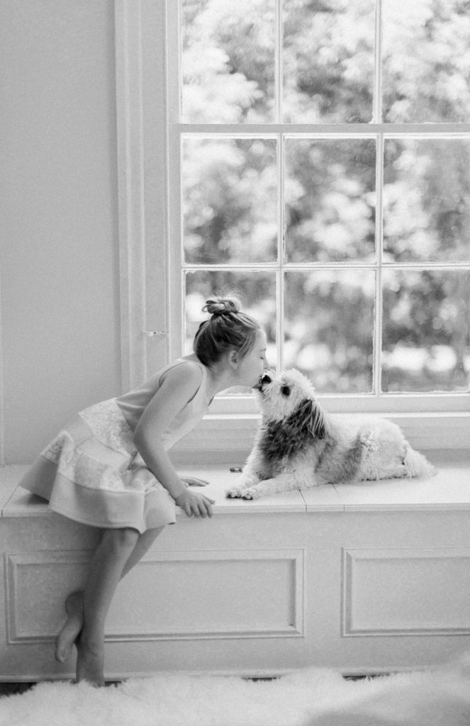 Photo of little girl kissing her dog in Athens Ga